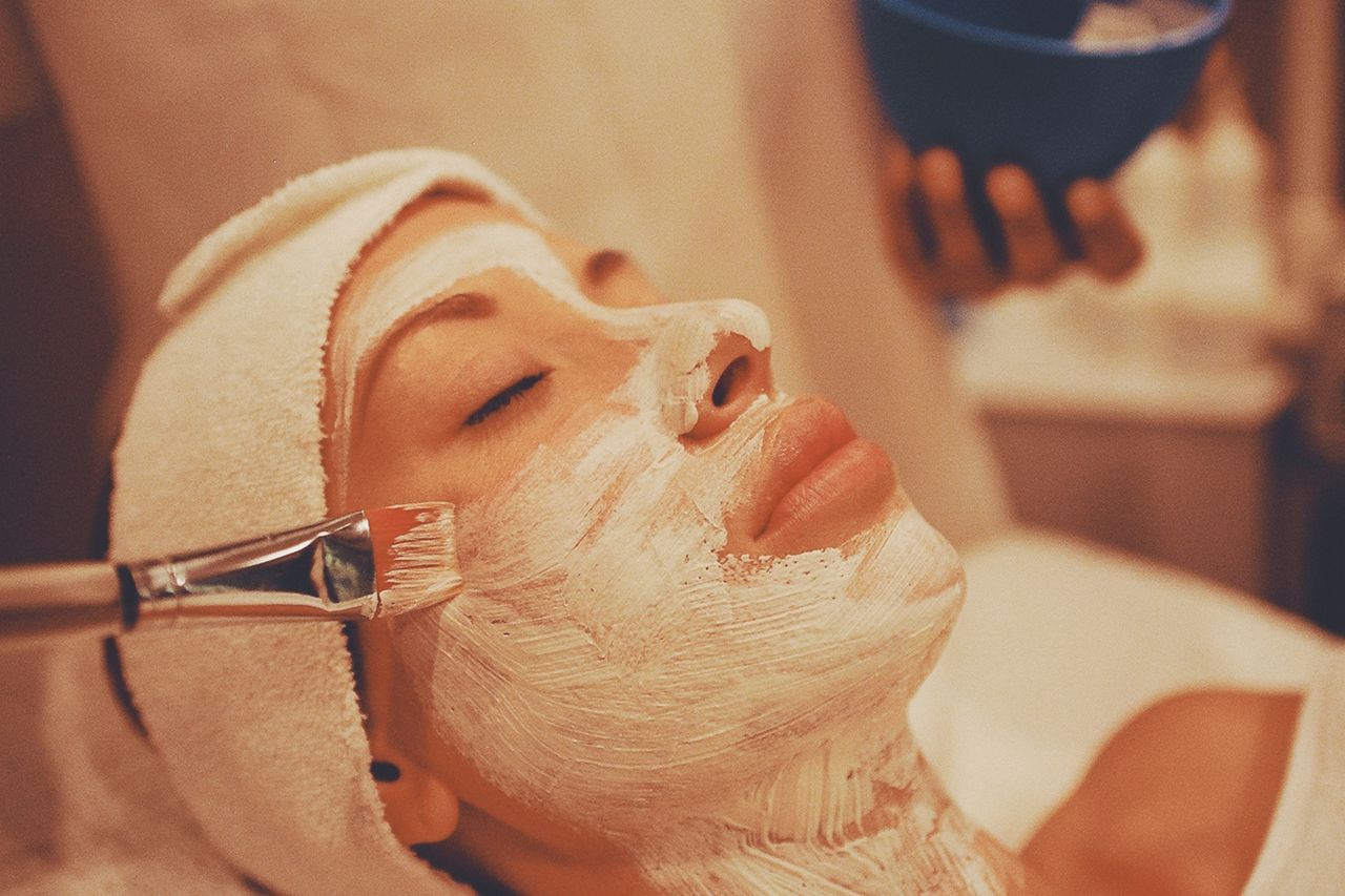 A person receiving a rejuvenating facial mask treatment in a calming spa environment.